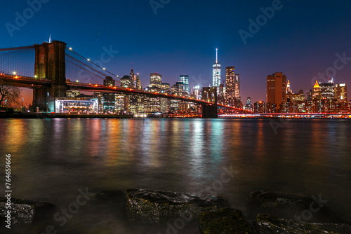  Brooklyn Bridge with lower Manhattan skyline in New York City at night  USA. Long exposure at night