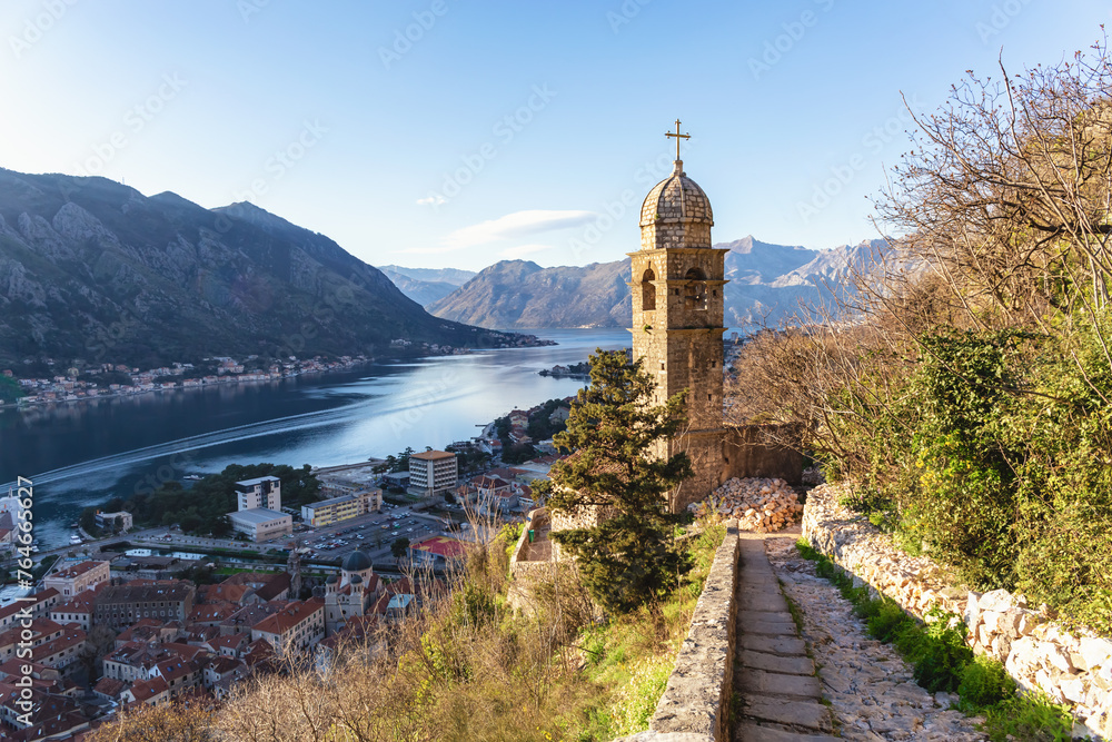 Church of Our Lady of Remedy overlooking Kotor Bay, with a path leading to the serene Adriatic landscape in golden hour light. Kotor, Montenegro