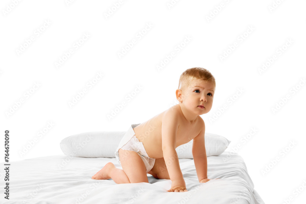 Playful little baby boy, child in diaper standing on bed on white background. Diaper brand ads, comfortable mobility for babies. Concept of childhood and family, care, parenthood, infancy and heath Playful little baby boy, child in diaper standing on bed on white background. Diaper brand ads, comfortable mobility for babies. Concept of childhood and family, care, parenthood, infancy and heath