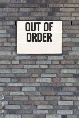 Out of Order message in lightbox on brick wall