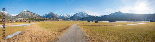wide pasture landscape around Oberstdorf tourist resort, view to allgau alps in march