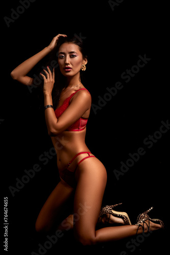 Art nude. Perfect body, sexy girl on the black background