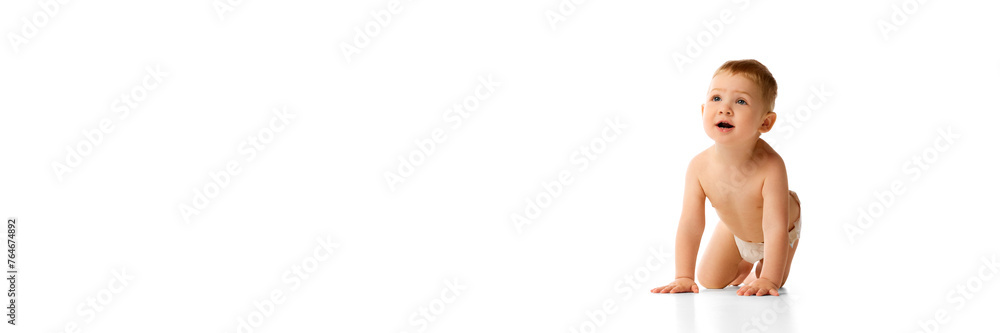 Happy little baby boy in diaper playing, crawling, smiling isolated over white studio background. Concept of childhood and family, care, parenthood, infancy and heath. Banner for ad Happy little baby boy in diaper playing, crawling, smiling isolated over white studio background. Concept of childhood and family, care, parenthood, infancy and heath. Banner for ad