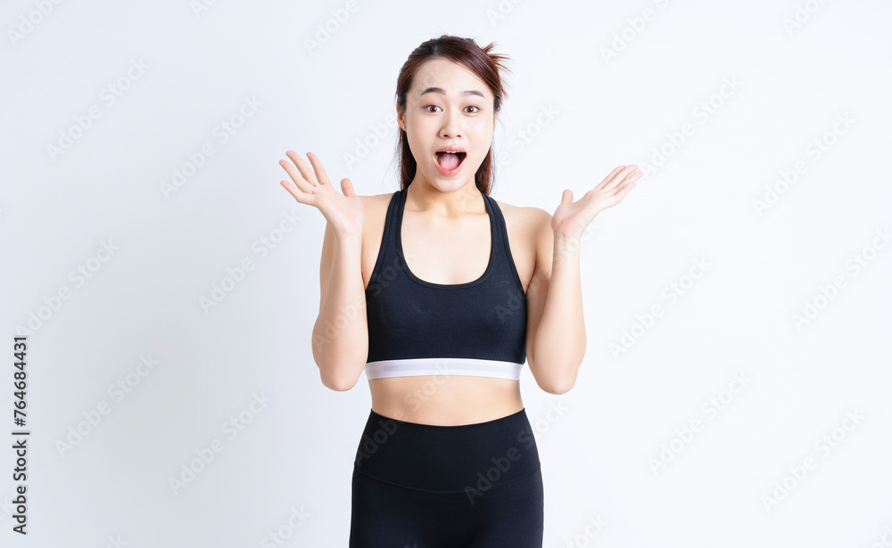 Young Asian woman wearing sportswear on white background Young Asian woman wearing sportswear on white background