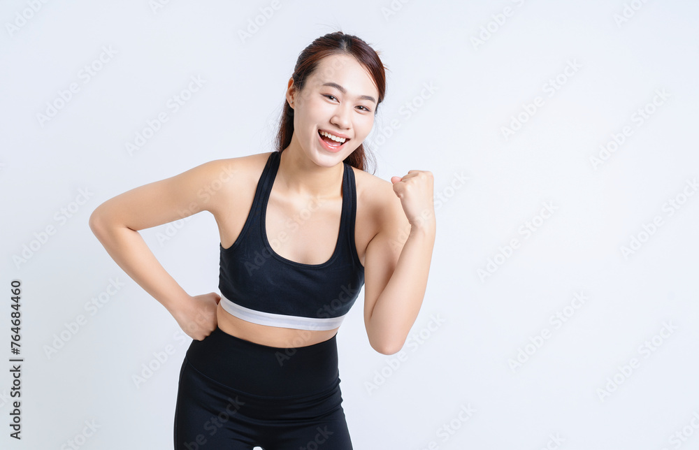 Young Asian woman wearing sportswear on white background Young Asian woman wearing sportswear on white background