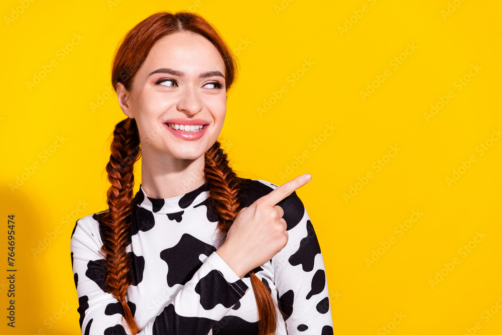 Photo of dreamy thoughtful lady dressed cowskin top looking showing finger empty space isolated yellow color background - obrazy, fototapety, plakaty 