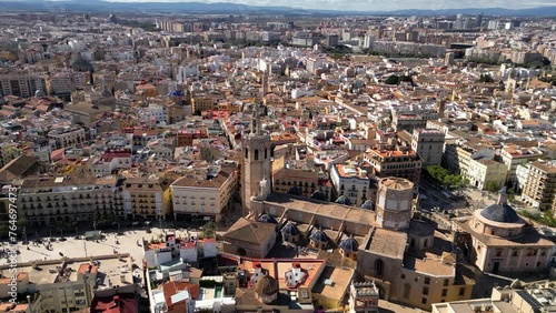 Cinematic aerial view of old town center of Valencia. View of Cathedral of Valencia and Plaza de la Reina. Drone circling above the city center. Famous travel destination. Medieval historic city.