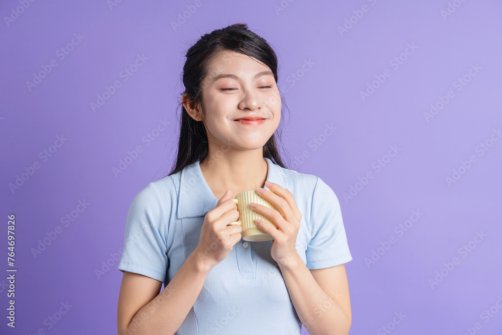 Photo of young Asian girl on purple background Photo of young Asian girl on purple background