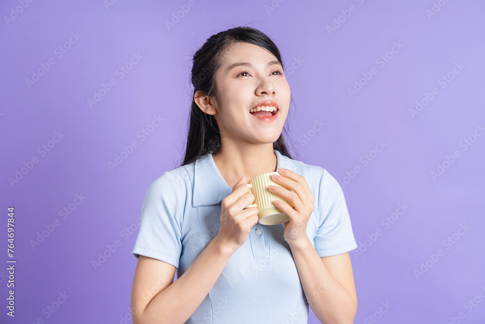 Photo of young Asian girl on purple background Photo of young Asian girl on purple background