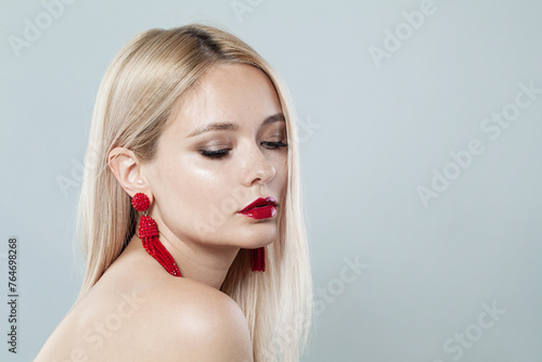 Glorious young blonde lady with fresh clear skin and long smooth straight hairstile on white background photo