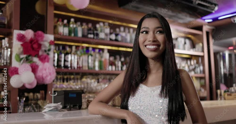 A young Asian woman with long black hair sips wine in a restaurant on vacation. Feel relaxed during work in the bar counter. entertainment place. Concept real person A young Asian woman with long black hair sips wine in a restaurant on vacation. Feel relaxed during work in the bar counter. entertainment place. Concept real person