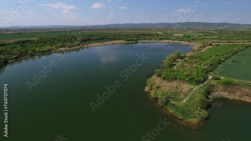 Beautiful aerial video of clean lake under clear blue sky in countryside photo