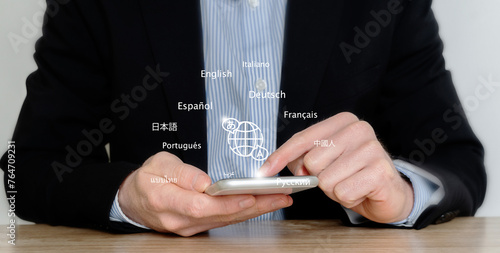 Person uses a mobile smartphone with a translation application to translate foreign languages. Translator app and language education concept. e-learning.