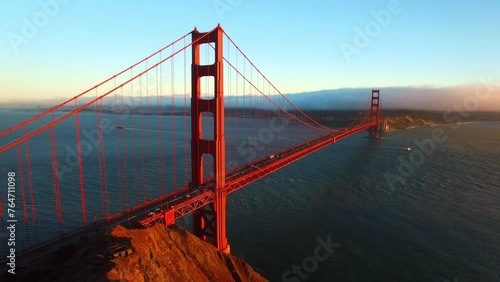 Aerial Panning Scenic View Of Golden Gate Bridge Over Wavy Bay Against Cloudy Sky - San Francisco, California