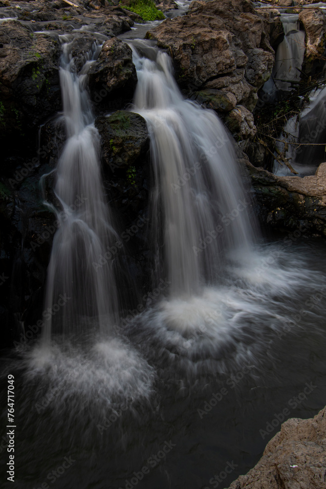 Fototapeta premium Long exposure to the waterfall on the river