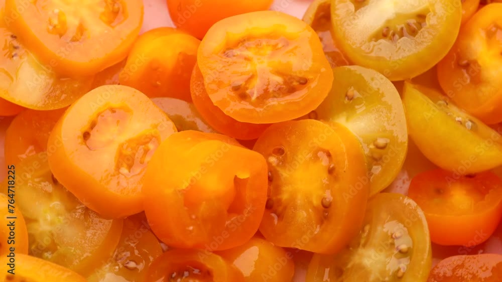 yellow cherry tomato slices, rotation in circle. slice tomato, Turning. selective focus. yellow background yellow cherry tomato slices, rotation in circle. slice tomato, Turning. selective focus. yellow background
