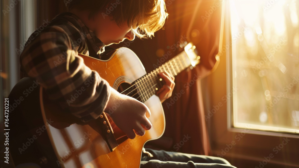 Child's musical journey begins with a soft sunset glow on his guitar. - obrazy, fototapety, plakaty 