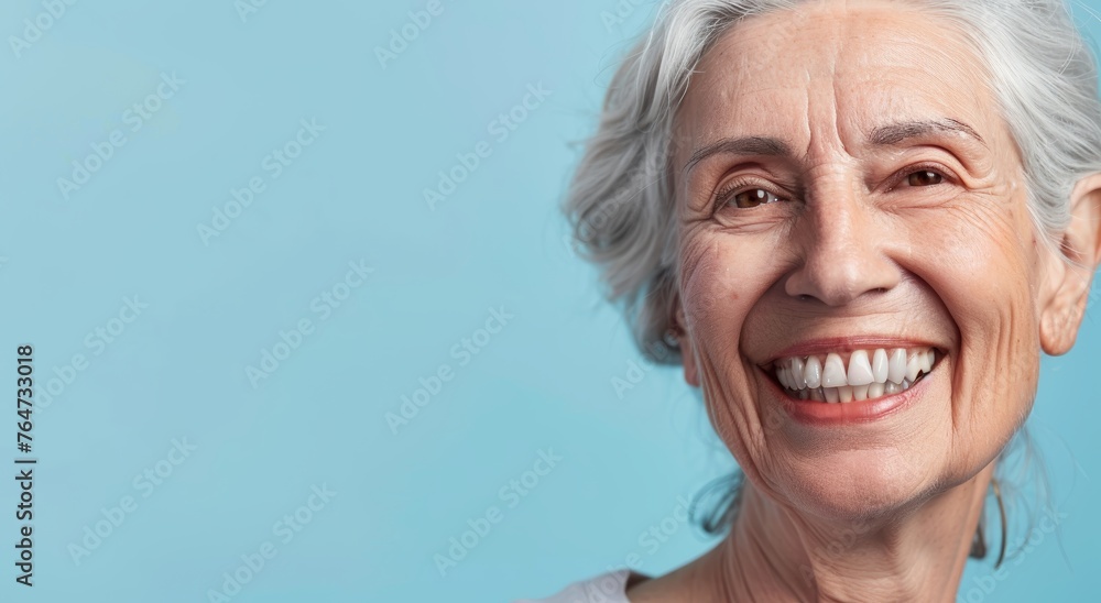 A happy old woman with a bright smile after a denture prosthesis operation. Dental surgery at a medical clinic or dentist. A happy old woman with a bright smile after a denture prosthesis operation. Dental surgery at a medical clinic or dentist.