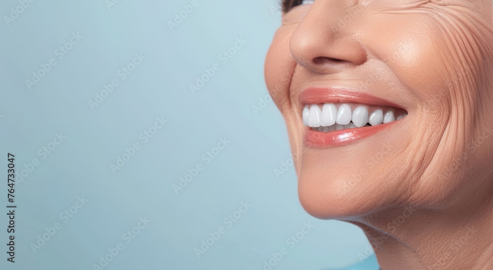Obraz premium A happy old woman with a bright smile after a denture prosthesis operation. Dental surgery at a medical clinic or dentist.