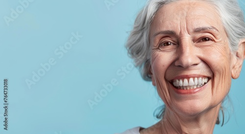 A happy old woman with a bright smile after a denture prosthesis operation. Dental surgery at a medical clinic or dentist. photo