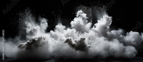 An abstract image of a cloud of white smoke against a dark black background, creating a contrast in colors and texture