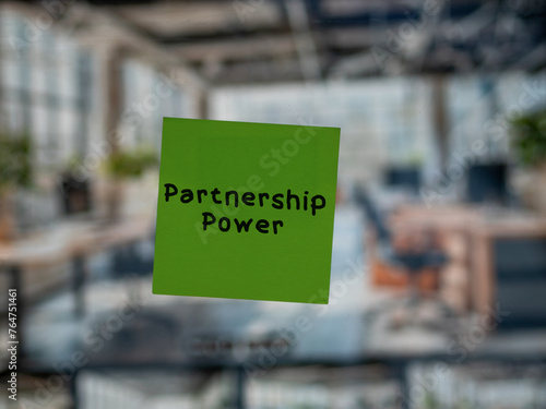 Post note on glass with 'Partnership Power'.