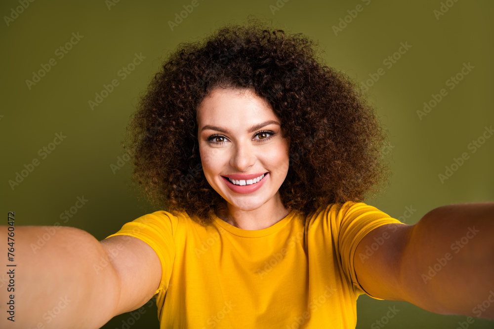 Selfie photo of young happy woman chevelure holding camera toothy beaming smile spending free time alone isolated on khaki color background Selfie photo of young happy woman chevelure holding camera toothy beaming smile spending free time alone isolated on khaki color background