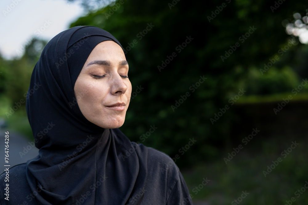 A Muslim woman wearing a hijab stands amidst lush greenery, symbolizing serenity and the connection between faith and nature. A Muslim woman wearing a hijab stands amidst lush greenery, symbolizing serenity and the connection between faith and nature.