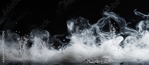 Smoke is ascending from a cooking pan placed on a dark black surface