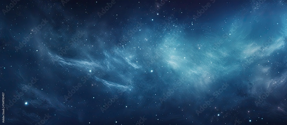 Fototapeta premium A close-up image of a deep blue sky filled with glittering stars and a few wispy clouds