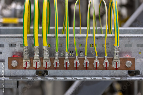Picture of electrical grounding on a copper rail in a industrial area, it prevents hazard in electrical shortcut situations