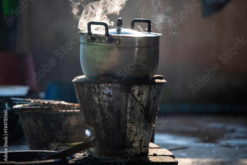 Cooking rice using charcoal in the past and use a charcoal stove and Anglo stove