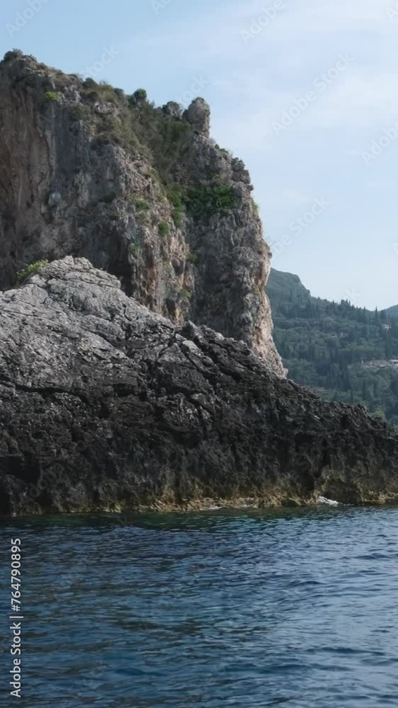 boat tour near Corfu island attractions deep clean clear water mountains natural spring passing boat people. tourists and travelers boat tour near Corfu island attractions deep clean clear water mountains natural spring passing boat people. tourists and travelers