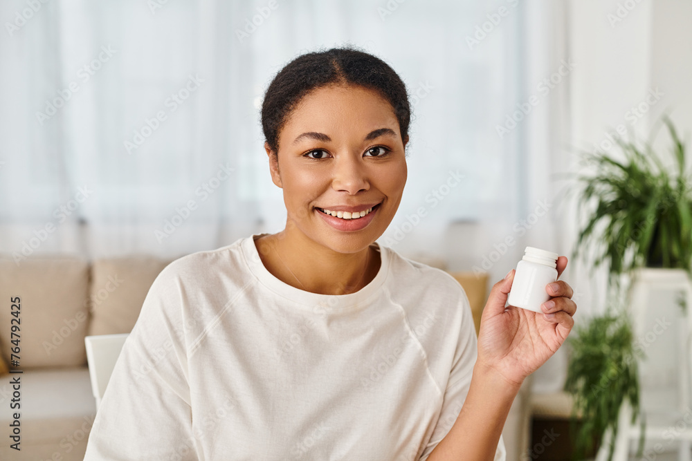 portrait of happy african american nutritionist holding supplements in a bottle for healthy diet portrait of happy african american nutritionist holding supplements in a bottle for healthy diet