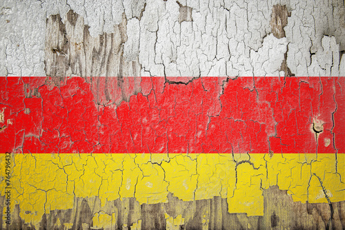 South Ossetia flag painted on the cracked wall photo