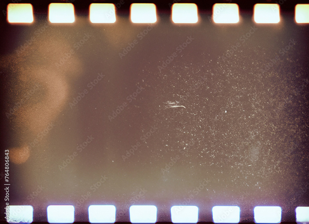 Blank grained film strip texture background with heavy grain, dust and light leaks; 35 mm negative effect photo