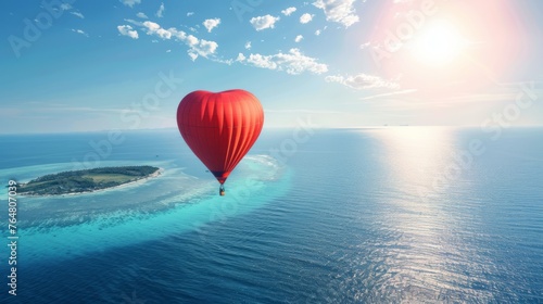 A hot air balloon is seen flying high above a small island surrounded by water. The colorful balloon stands out against the clear sky as it casts a shadow on the island below.