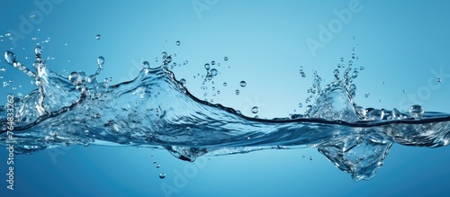 High-speed photograph of water splashing on a vibrant blue background, capturing the dynamic motion and energy of the liquid