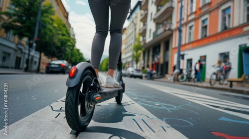 A person riding an electric scooter through a city street with bike lanes and pedestrian-friendly infrastructure,  promoting eco-friendly urban mobility and reducing carbon emissions photo