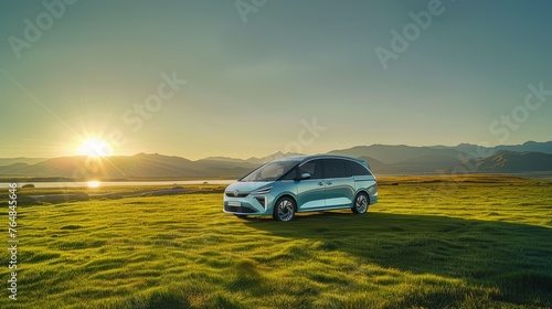  A light blue electric MPV is elegantly parked on a vast green grassland photo