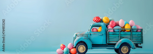 Cute blue truck full of colorful easter eggs on blue background with copy space, easter is here concept, perfect for easter holiday promotions and designs