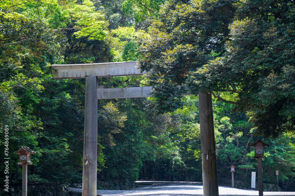 wood bridge and Tori gate at The Grand Shrine of Ise or Ise Jingu Naiku, Inner Sanctuary in the natural green scenery background, Ise City, Mie., Japan wood bridge and Tori gate at The Grand Shrine of Ise or Ise Jingu Naiku, Inner Sanctuary in the natural green scenery background, Ise City, Mie., Japan
