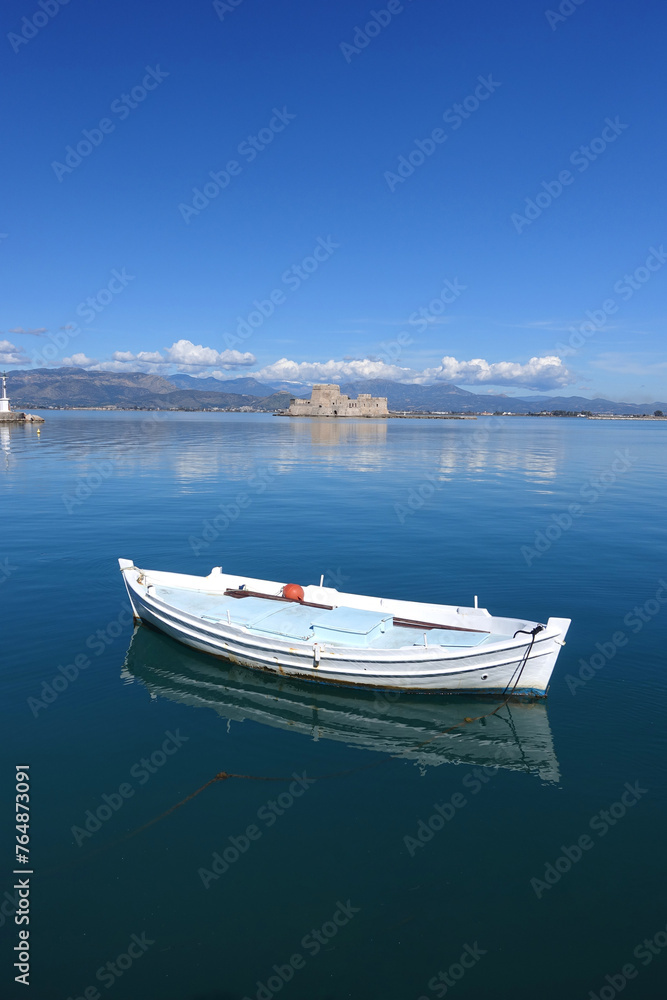 Beautiful small castle of Bourtzi built at sea a popular attraction in city of Nafplio former capital of Greece as seen at spring morning with nice white clouds and deep blue sky, Argolida, Greece Beautiful small castle of Bourtzi built at sea a popular attraction in city of Nafplio former capital of Greece as seen at spring morning with nice white clouds and deep blue sky, Argolida, Greece