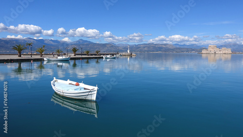Traditional fishing boats anchored in small port of Nafplio city, Argolida, Peloponnese, Greece