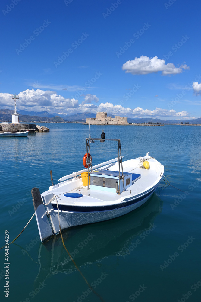 Beautiful small castle of Bourtzi built at sea a popular attraction in city of Nafplio former capital of Greece as seen at spring morning with nice white clouds and deep blue sky, Argolida, Greece Beautiful small castle of Bourtzi built at sea a popular attraction in city of Nafplio former capital of Greece as seen at spring morning with nice white clouds and deep blue sky, Argolida, Greece