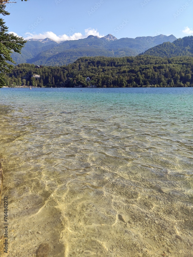 Beautiful lake Bohinj in Slovenia. Alpine lake Bohinj surrounded by mountains in Triglav National Park , Slovenia, with calm water on a sunny day. Beautiful lake Bohinj in Slovenia. Alpine lake Bohinj surrounded by mountains in Triglav National Park , Slovenia, with calm water on a sunny day.