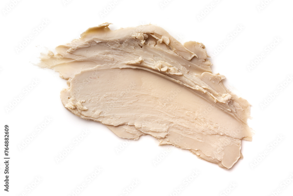 Close-up view of a textured beige cosmetic clay smear Close-up view of a textured beige cosmetic clay smear