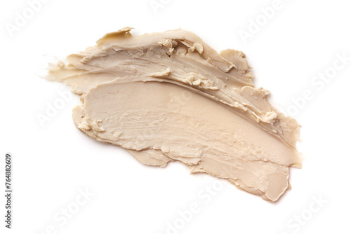 Close-up view of a textured beige cosmetic clay smear