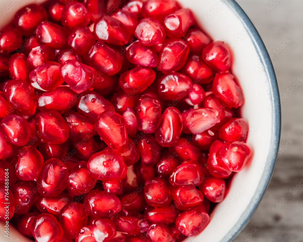Close up of Juicy Organic Pomegranate Seeds in a Bowl Close up of Juicy Organic Pomegranate Seeds in a Bowl