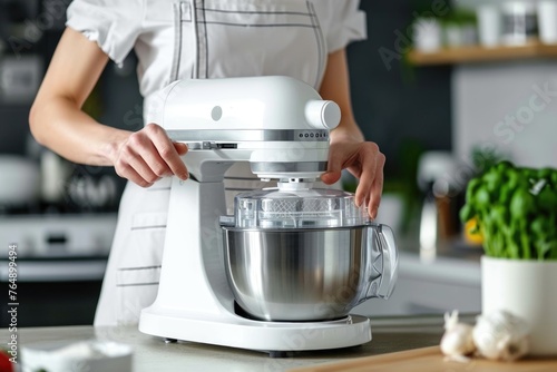 Woman adjusts food processor speed for pastry chef